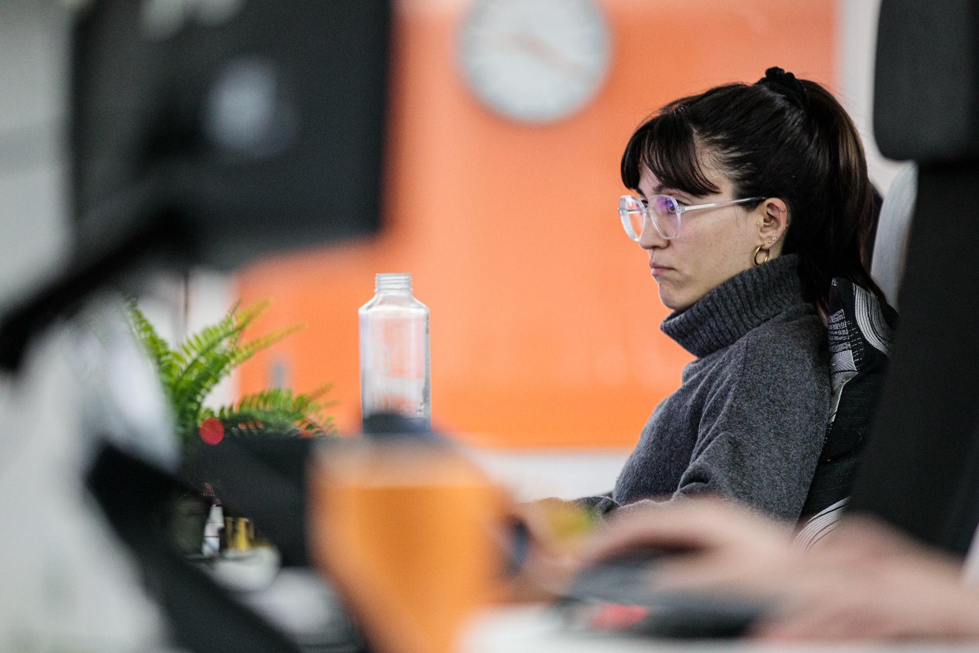 A female web designer focusing on her desktop computer